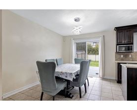 A dining room with a table and chairs.
