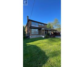A house with a lawn in front of it.