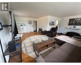 A living room with a television, couch, and coffee table.