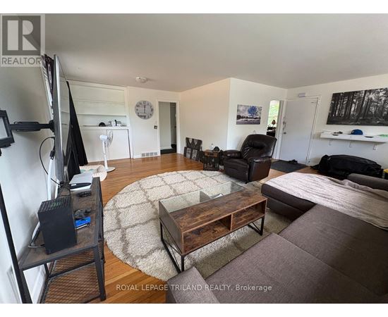 A living room with a television, couch, and coffee table.