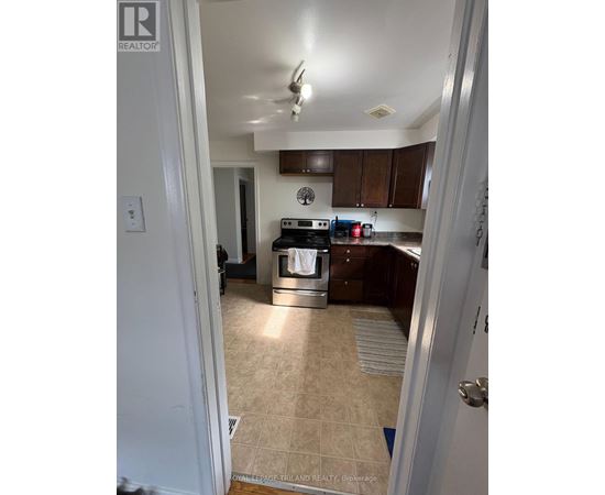 A kitchen with a tile floor and a stove top oven.