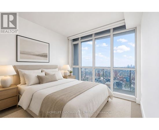 A bedroom with a large bed and a view of the city.