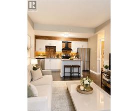 A modern kitchen with a white couch and a coffee table in the foreground.