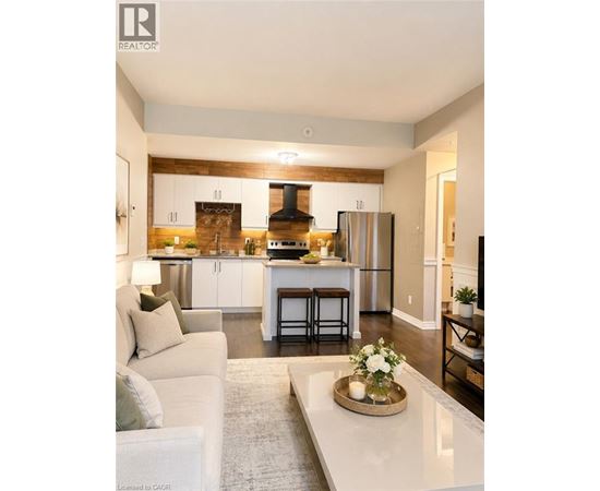 A modern kitchen with a white couch and a coffee table in the foreground.