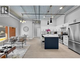 A modern kitchen with a dining area and a living room.