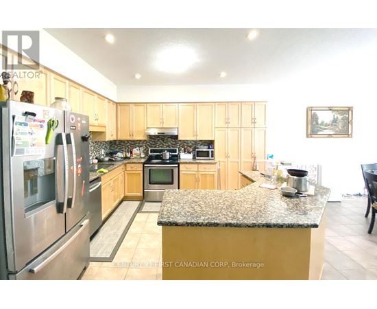 A kitchen with a granite counter top and wooden cabinets.