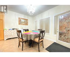A dining room with a table set for four.