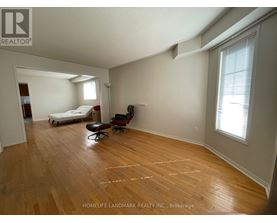 A room with wooden floors and a bed in it.