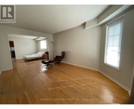 A room with wooden floors and a bed in it.