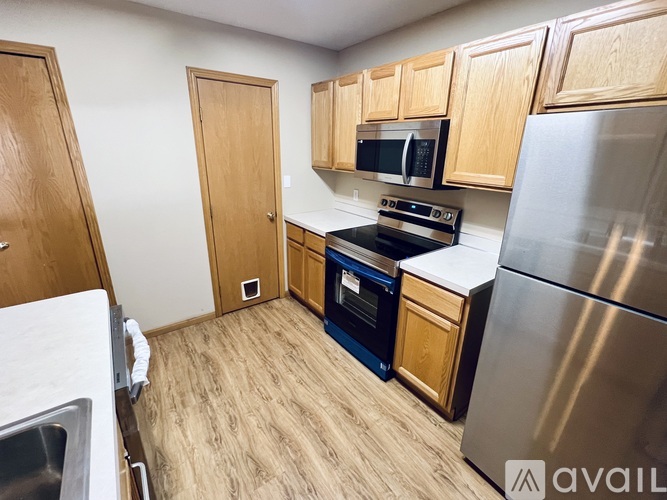 A kitchen with wooden cabinets and stainless steel appliances.