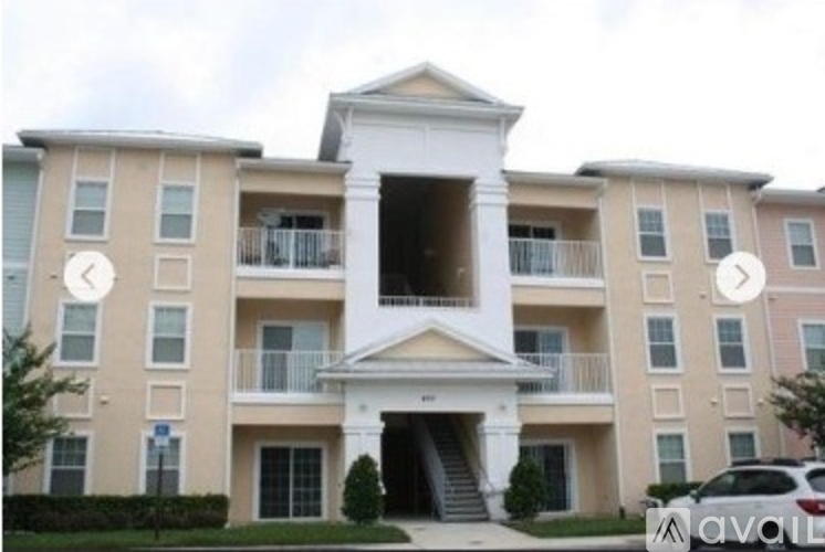 A large apartment building with a white entrance and balconies.