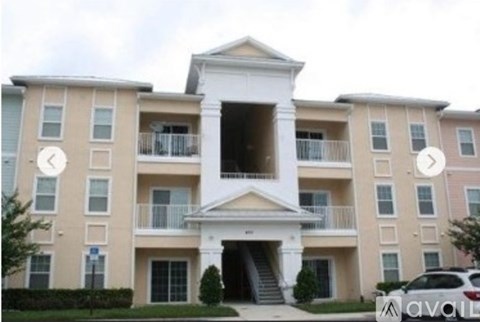 A large apartment building with a white entrance and balconies.