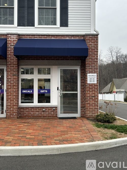 A storefront with a blue awning advertises decals and gifts.