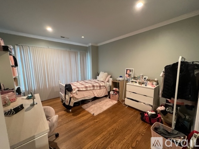 A bedroom with a bed, dresser, and mirror.