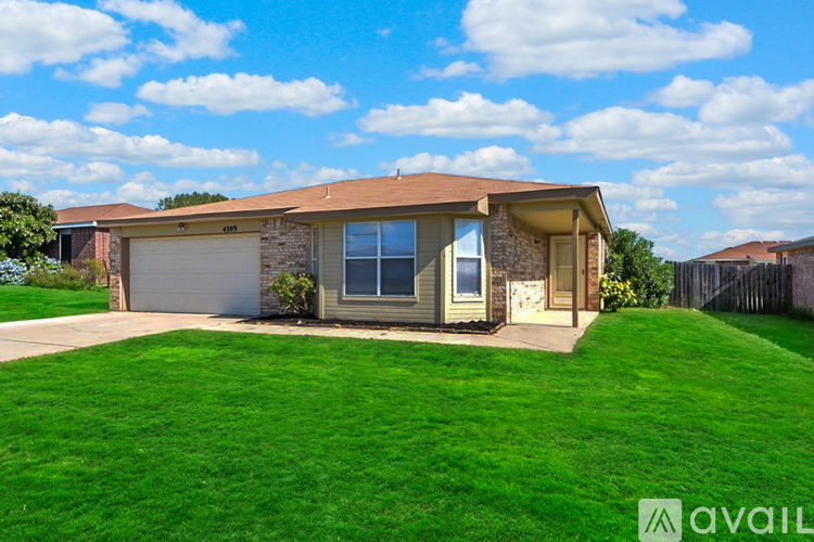 A house with a brown roof and a garage door is for sale.