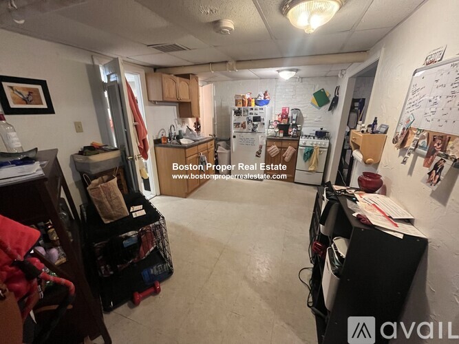 A room with a whiteboard and a website address on the wall.