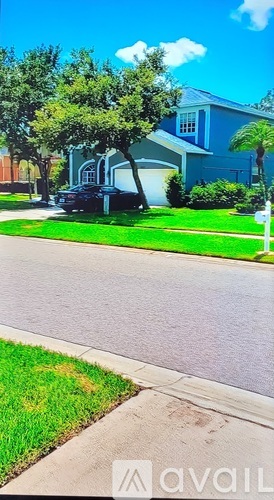 A blue house with a black car parked in front.