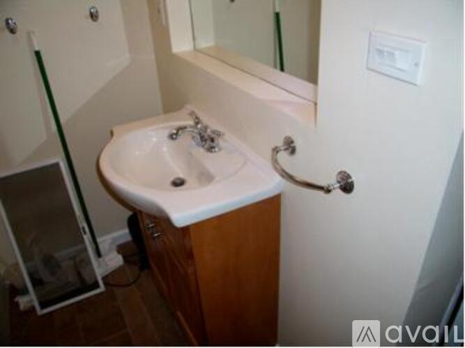 A small bathroom with a sink and mirror.