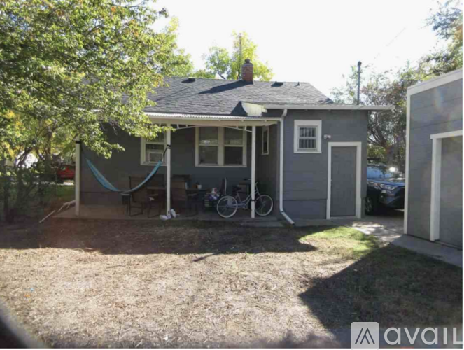 A small house with a porch and a bicycle parked outside.
