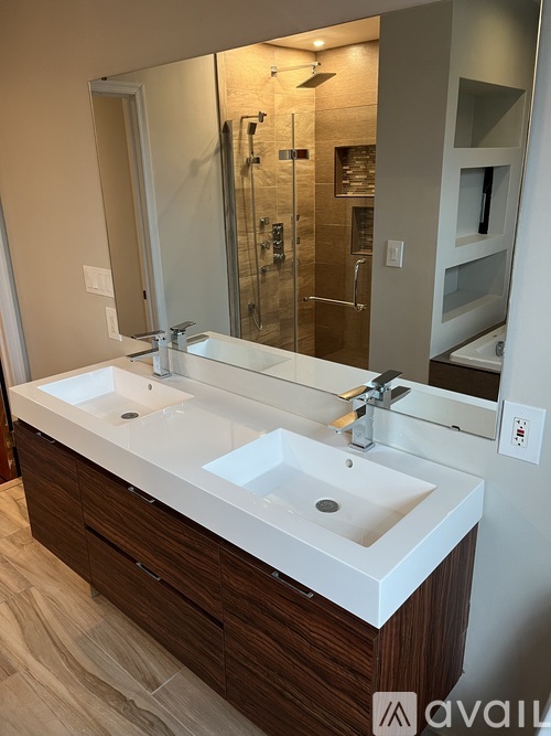 A bathroom with a white sink and a mirror.