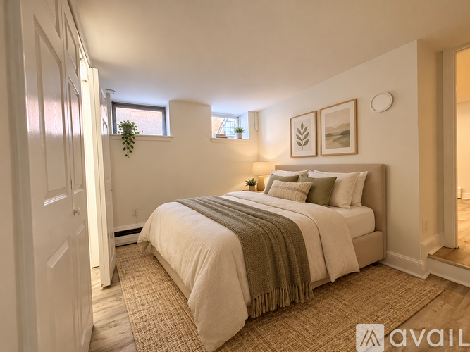 A bedroom with a large bed and a window.