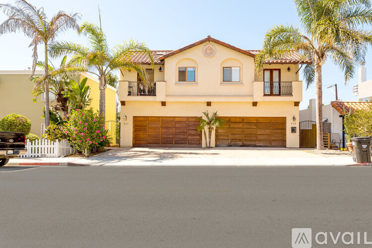A two-story house with a garage and a driveway.
