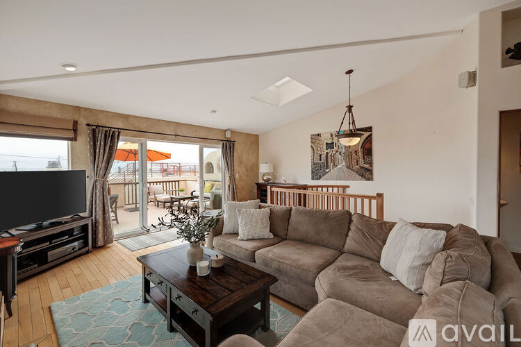 A living room with a brown couch and a coffee table.