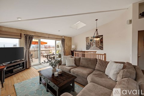 A living room with a brown couch and a coffee table.