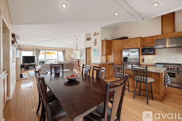 A kitchen with a table and chairs in the middle of the room.