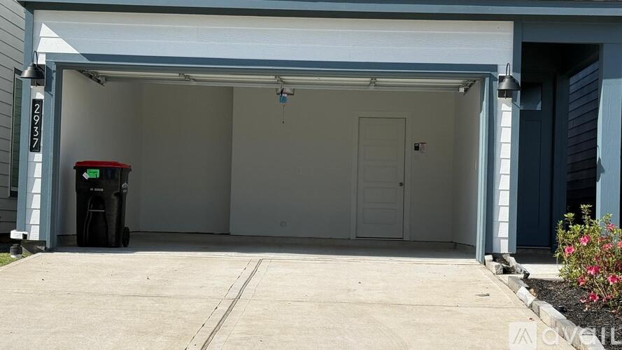 A car is parked in a garage with a white door.