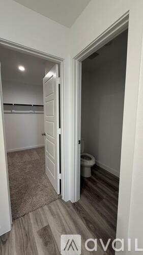 A small bedroom with a toilet in the corner.