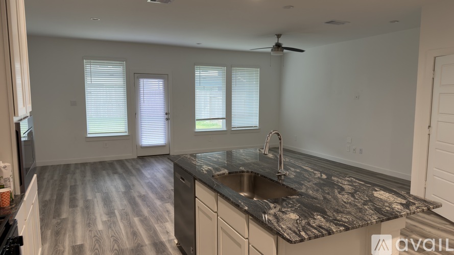 A kitchen with a sink and a window.