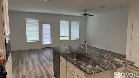 A kitchen with a sink and a window.