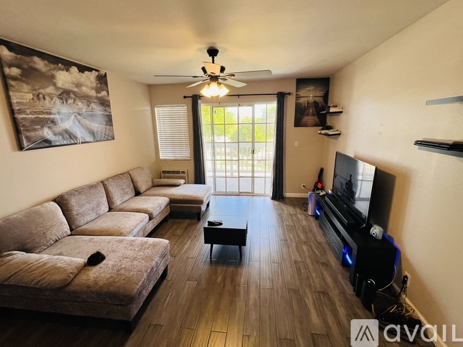 A living room with a brown couch and a flat screen TV.