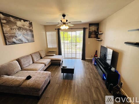 A living room with a brown couch and a flat screen TV.