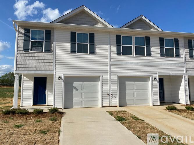 A two-story house with a garage is available for rent.