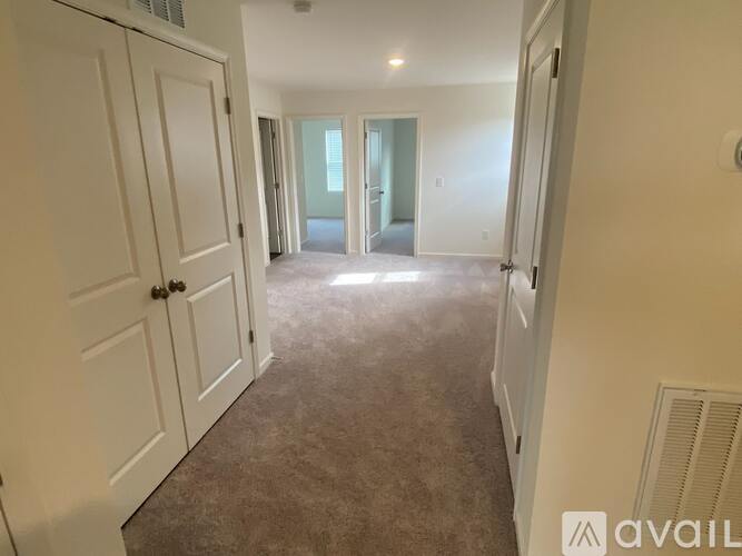 A room with carpeted floor and white walls.