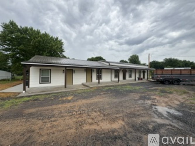 A house with a metal roof is available for sale.