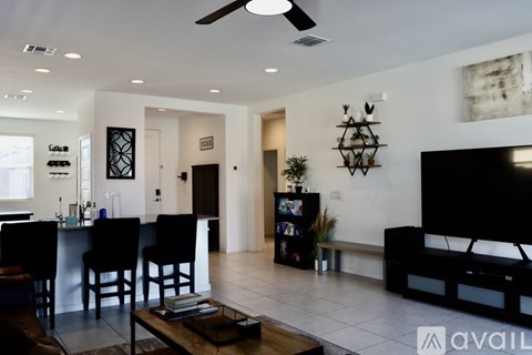 A living room with a black sofa and a television.