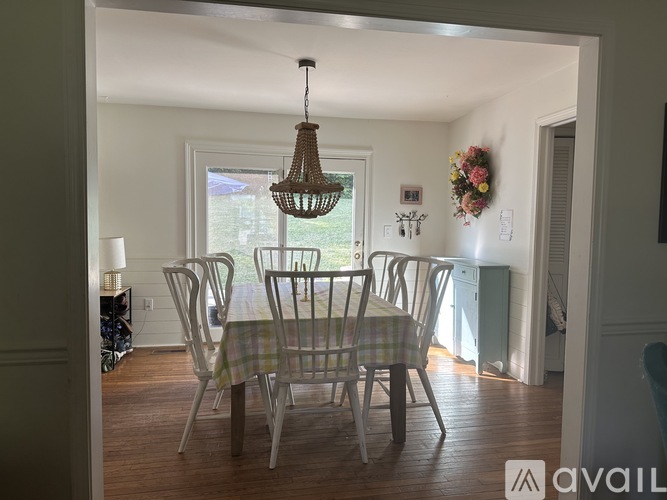 A dining room with a table and chairs.