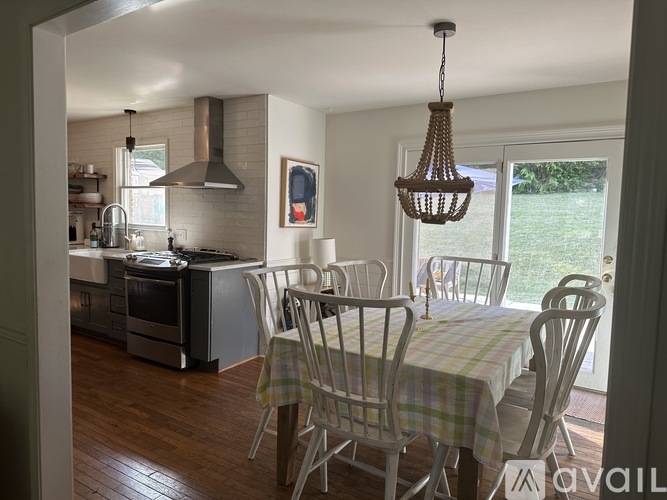 A kitchen with a table and chairs is available for rent.