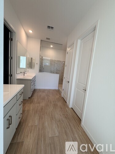 A bathroom with a vanity and a walk-in shower.