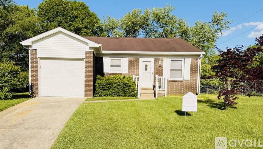 A house with a garage is for sale.