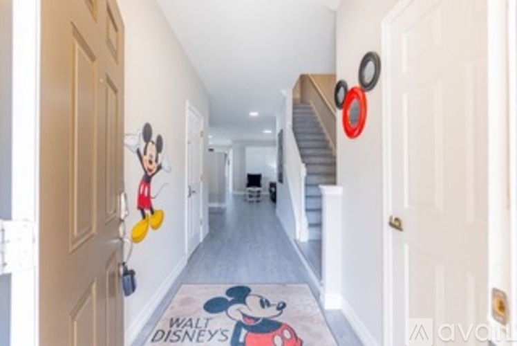 A hallway with a Mickey Mouse picture on the floor.
