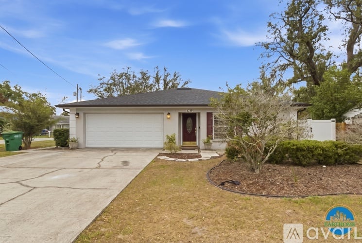 A house with a white garage door and a brown roof.