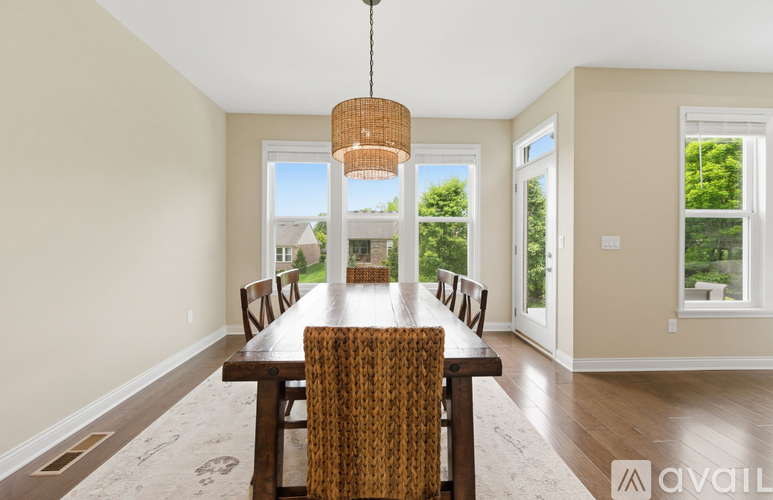 A dining room with a wooden table and chairs.
