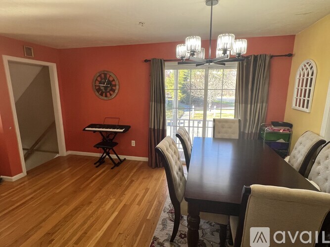 A dining room with a table and chairs.