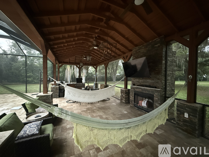 A modern living room with a glass table and a fireplace.