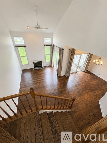 A living room with a television and a staircase.