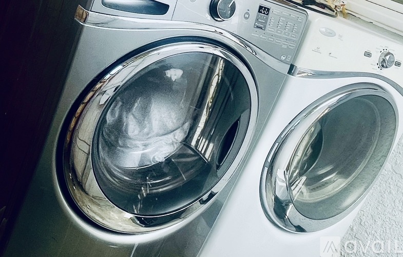 A front load washing machine with the door open.